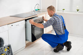 Picture of an oven repair. This photo was purchased from Adobe Stock. 